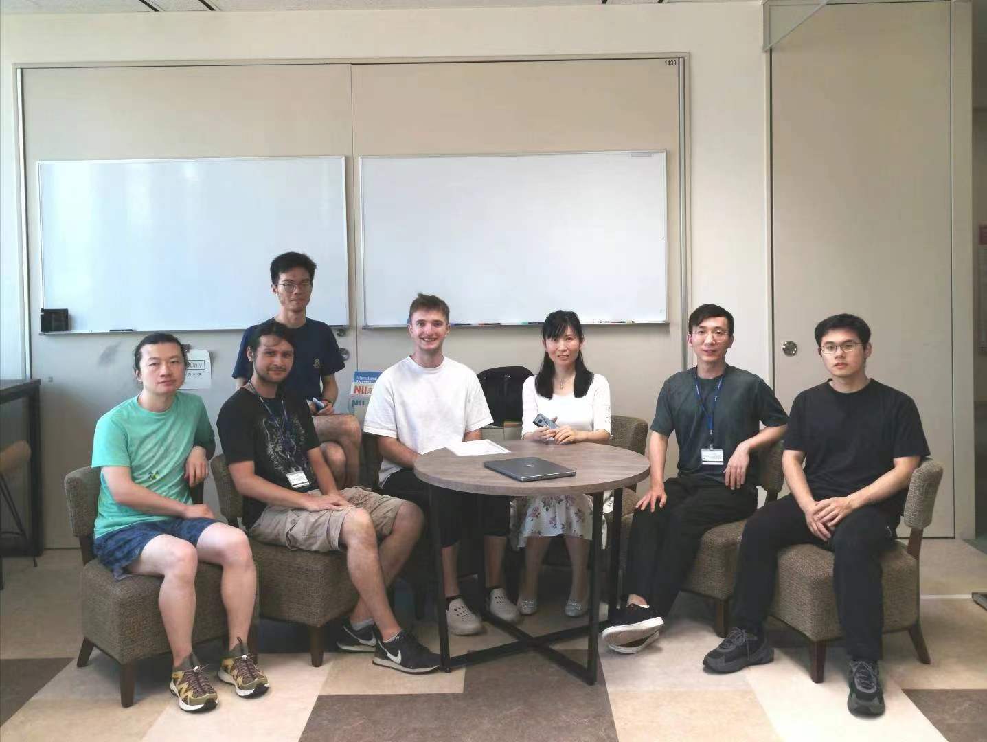 A group of researchers gathered in a seminar room at NII