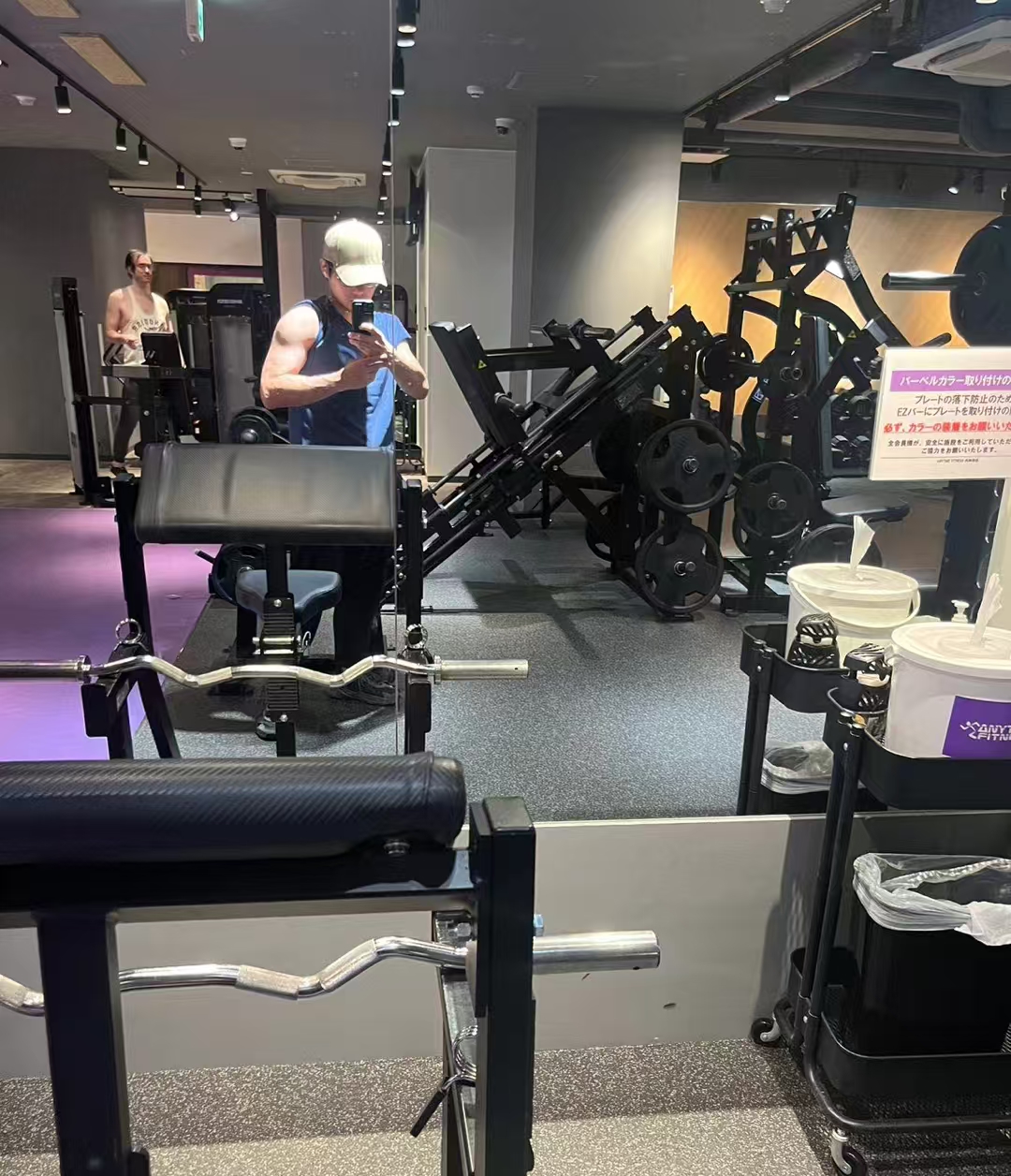 Taking a mirror photo among the weight machines at a gym in Tokyo