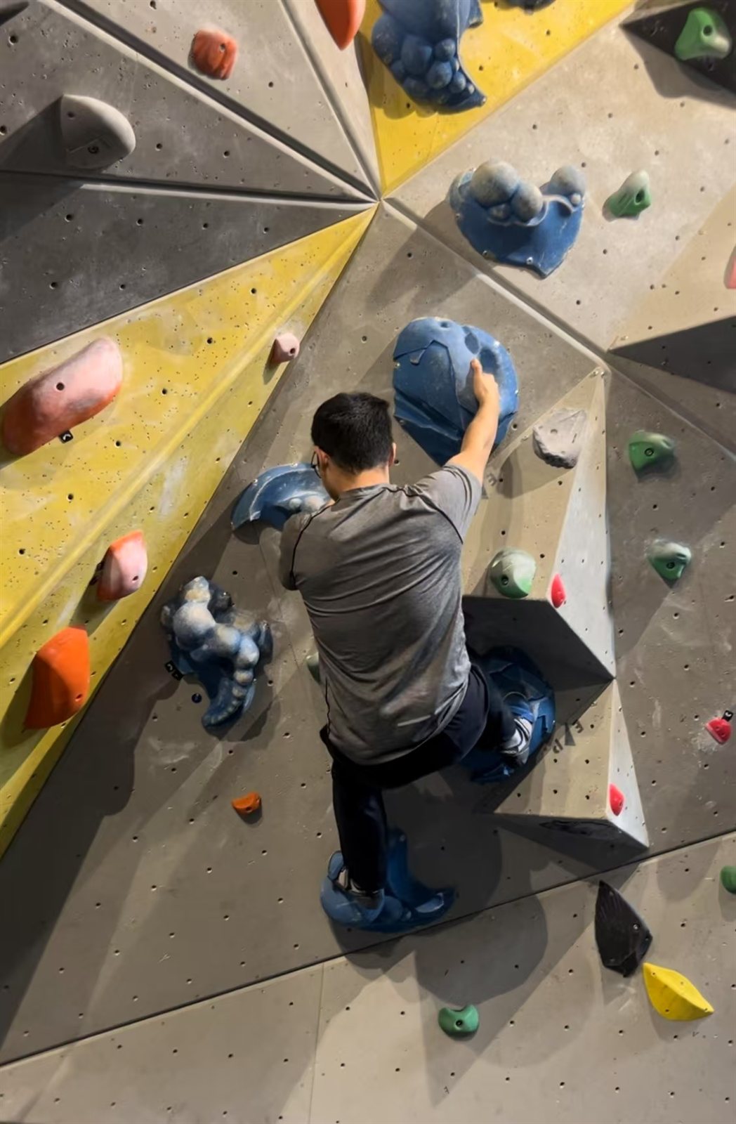 Wenjie climbing an indoor bouldering wall